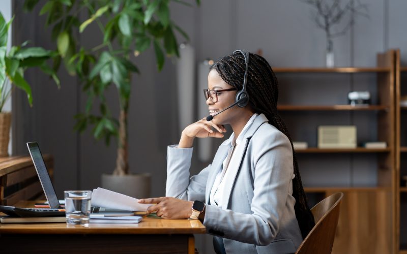 young-positive-african-woman-remote-recruiter-using-wireless-headset-to-communicate-with-candidates.jpg